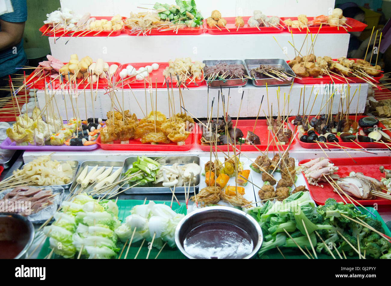 People buy and cook Lok Lok food malaysian style at restaurant in