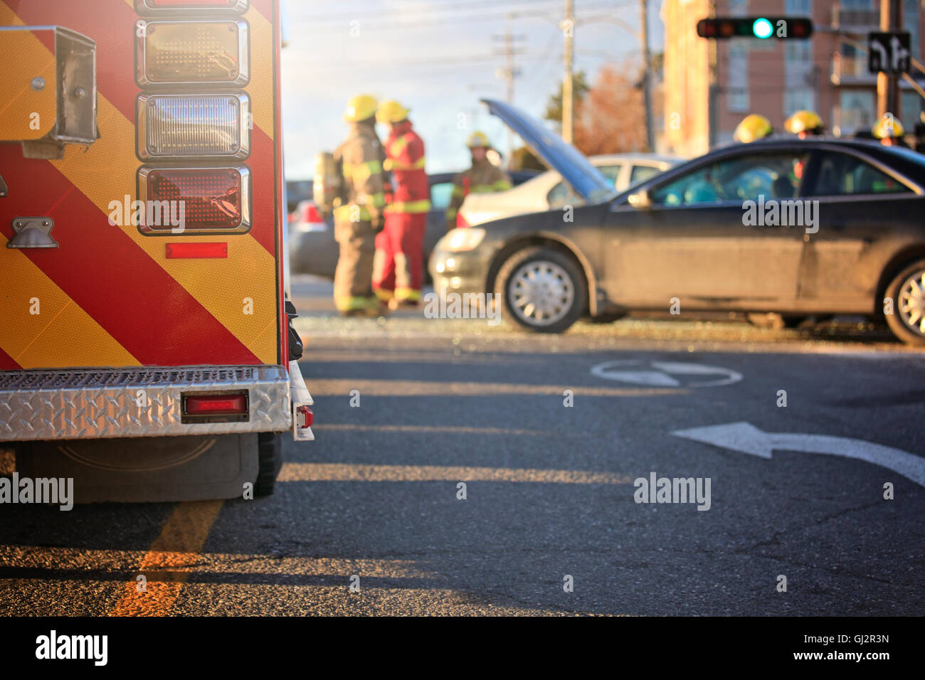 An accident scene on the road of a city with ambulance and fire fighter ...