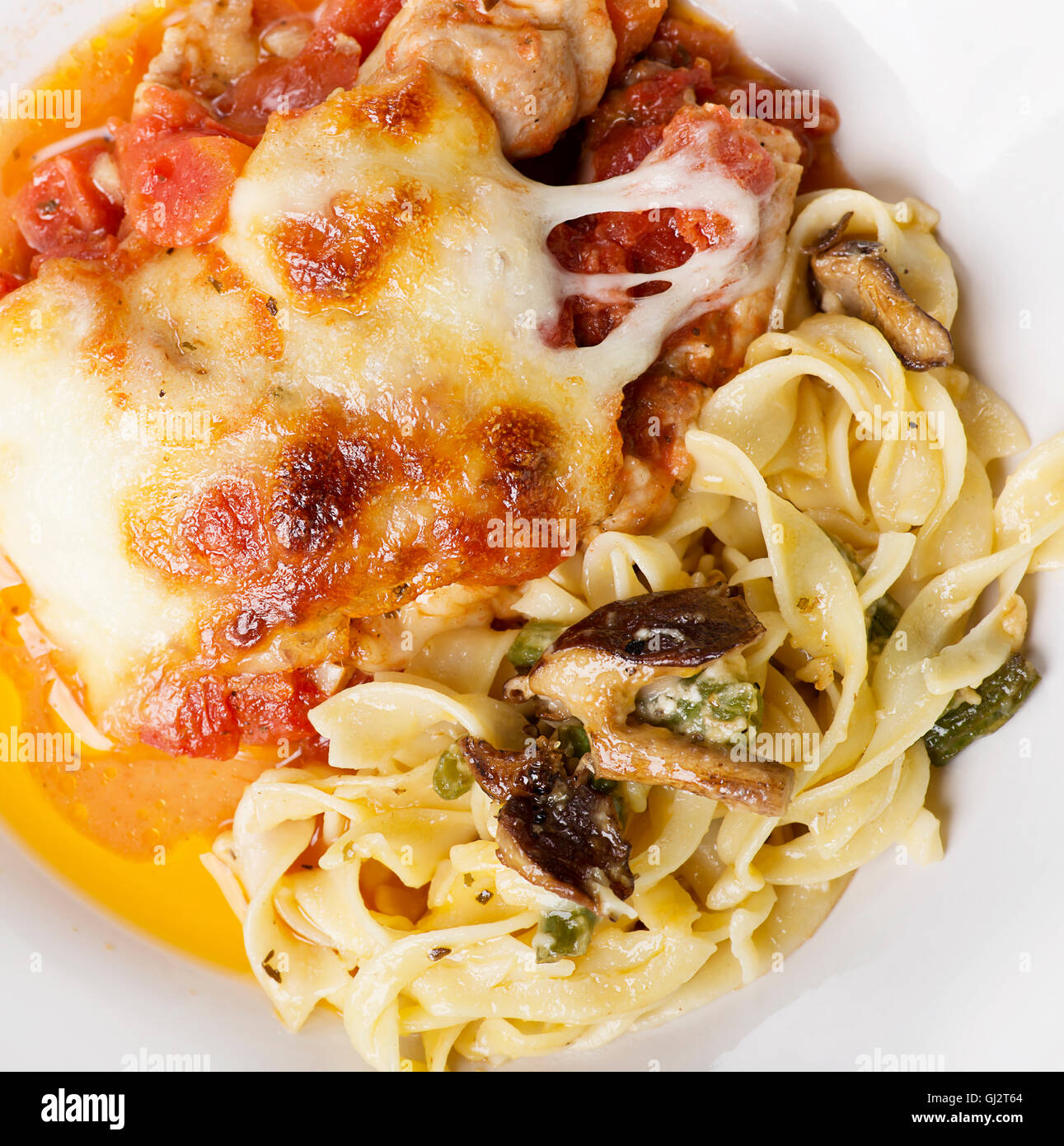 Pasta with Green Beans and Mushrooms and Parmesan Chicken Stock Photo