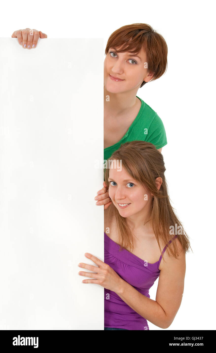 Two friendly young women holding a blank banner ad Stock Photo - Alamy