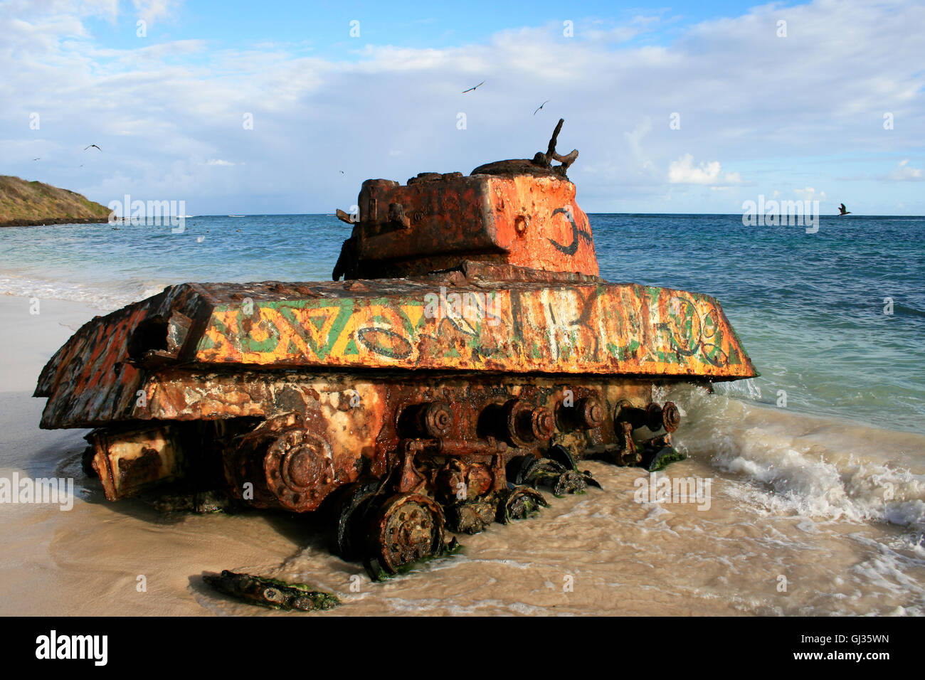Old rusted and painted remnants of an US army tank on the Flamenco beach, Culebra Island, Puerto Rico Stock Photo