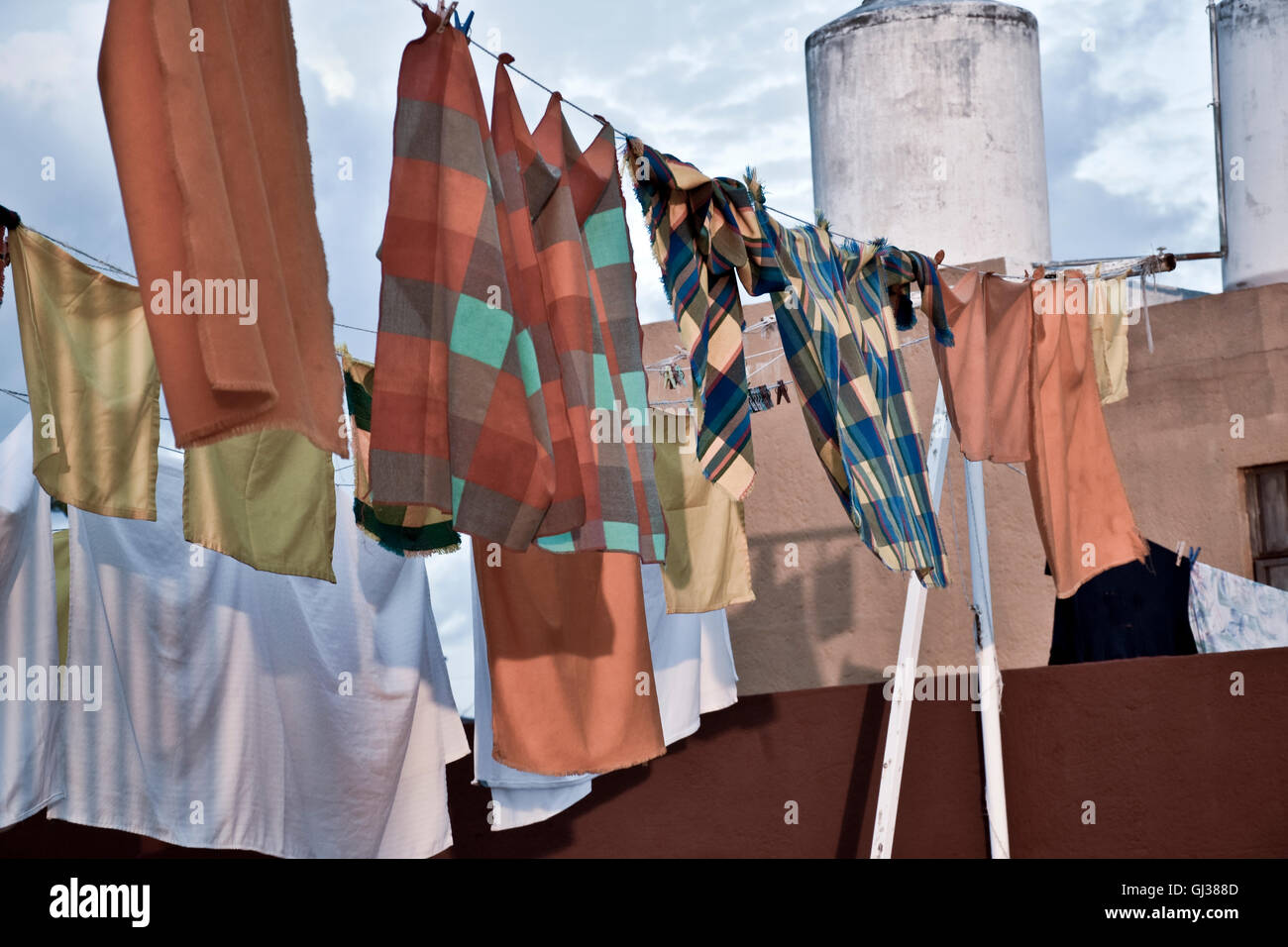 Orange laundry waving in breeze on clothesline in Acapulco, Mexico Stock Photo
