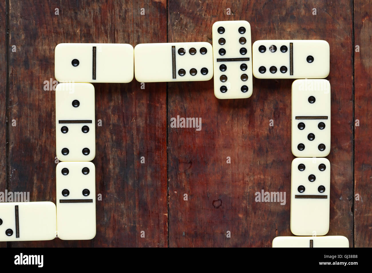 Gambling concept. Domino game closeup on nice old wooden background Stock Photo