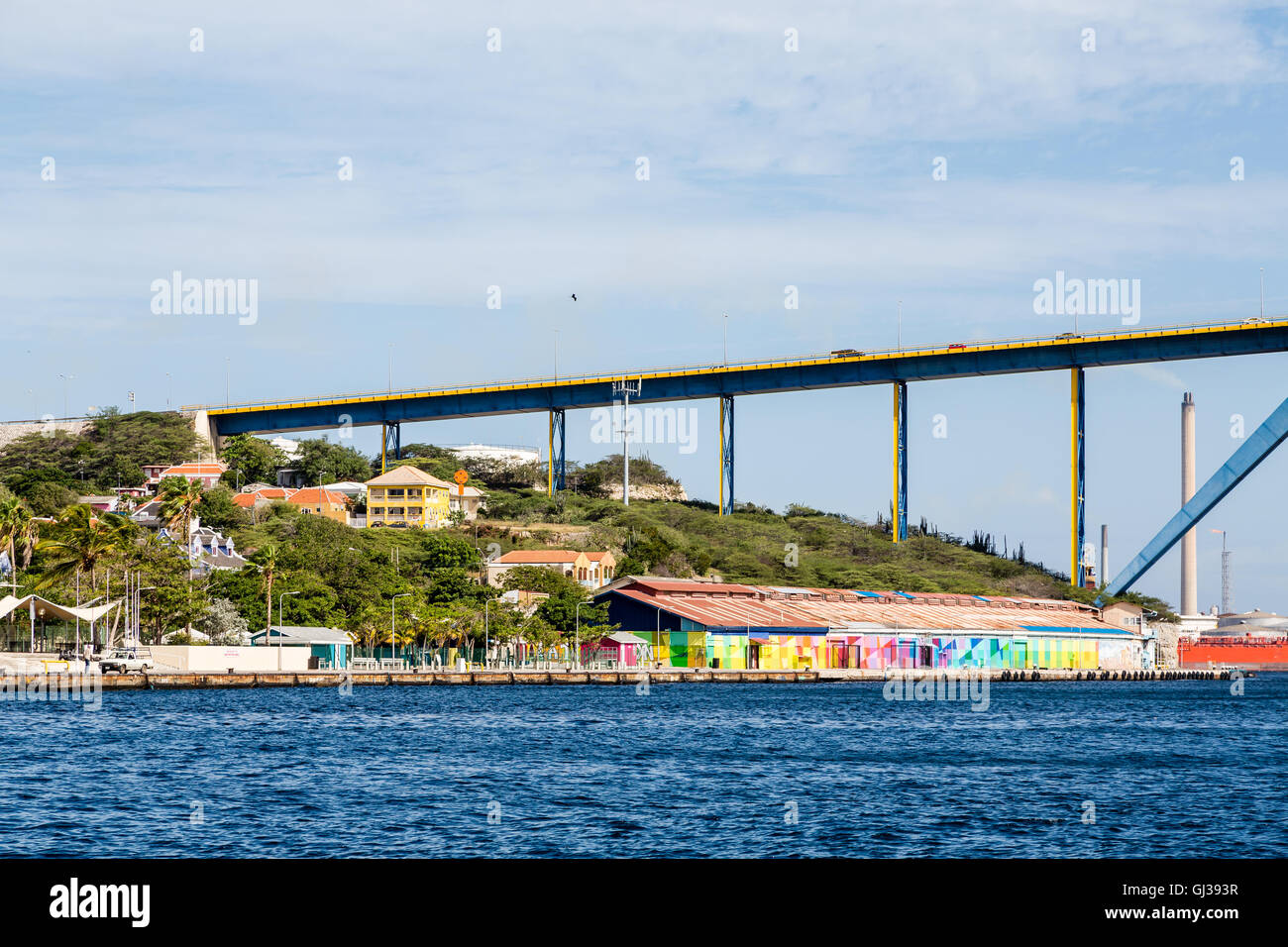Colorful buildings in Curacao under the blue sky bridge Stock Photo