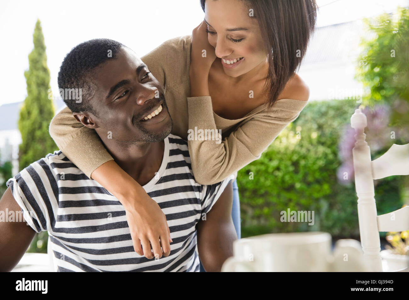Young woman with arms around man hi-res stock photography and images ...
