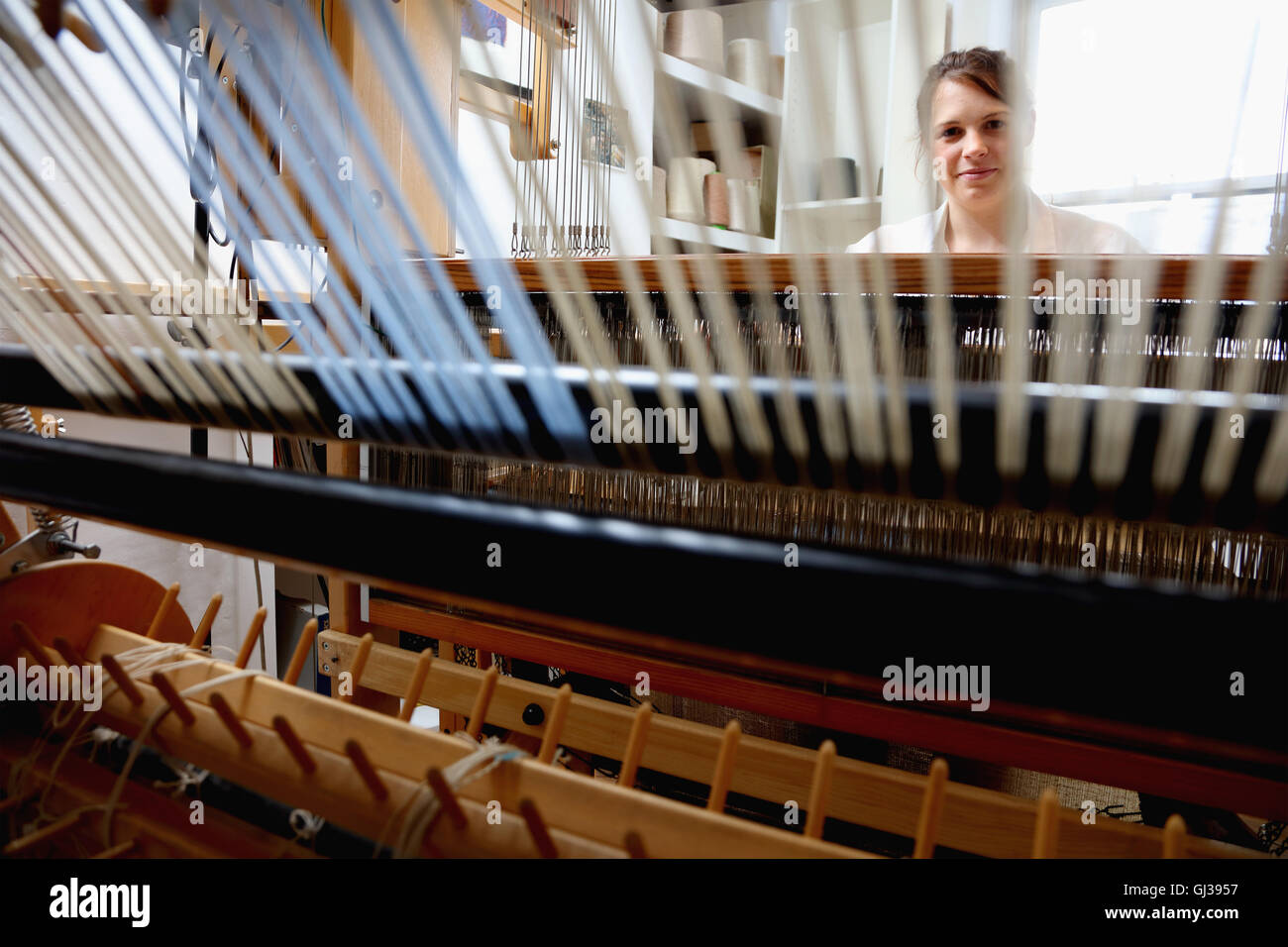 Young woman using loom Stock Photo
