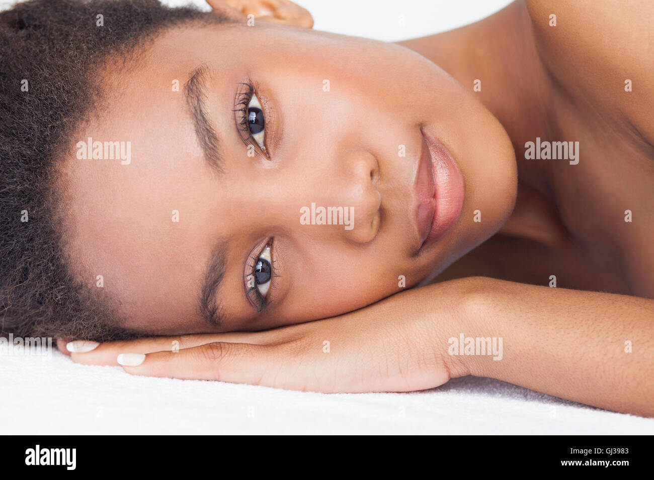 Headshot of woman lying down looking at camera Stock Photo