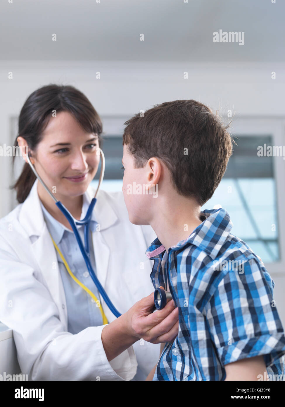 Doctor checking boy's breathing with stethoscope Stock Photo - Alamy