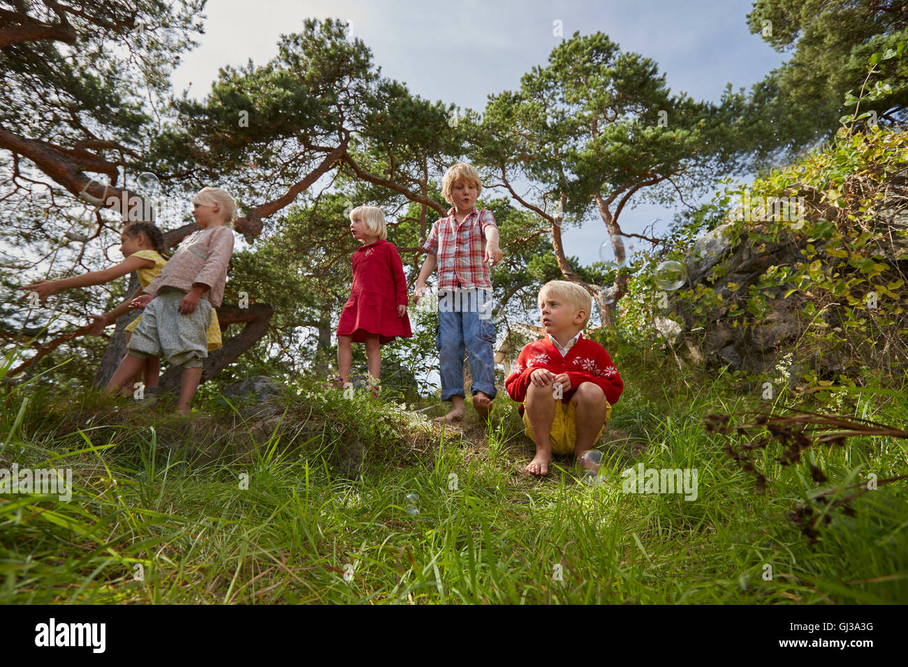 Small group of young friends playing outdoors Stock Photo