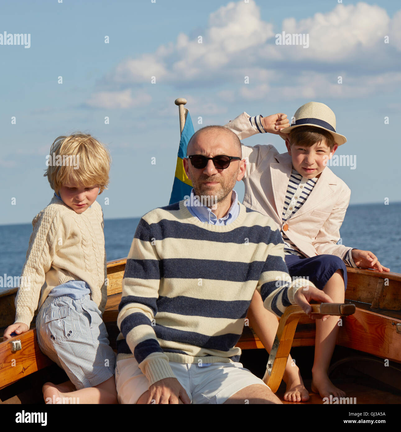 Father and sons on boat Stock Photo