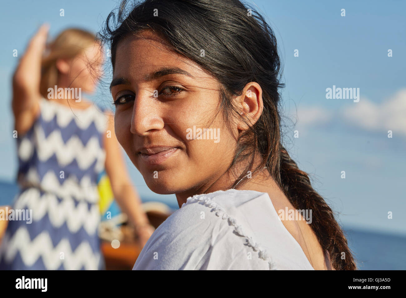 Young woman looking over shoulder at camera smiling Stock Photo