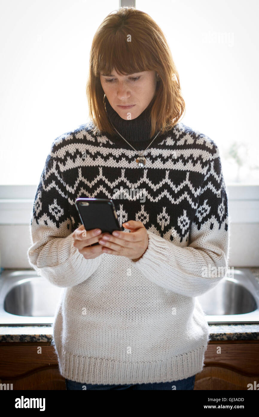 Mid adult woman texting hi-res stock photography and images - Alamy