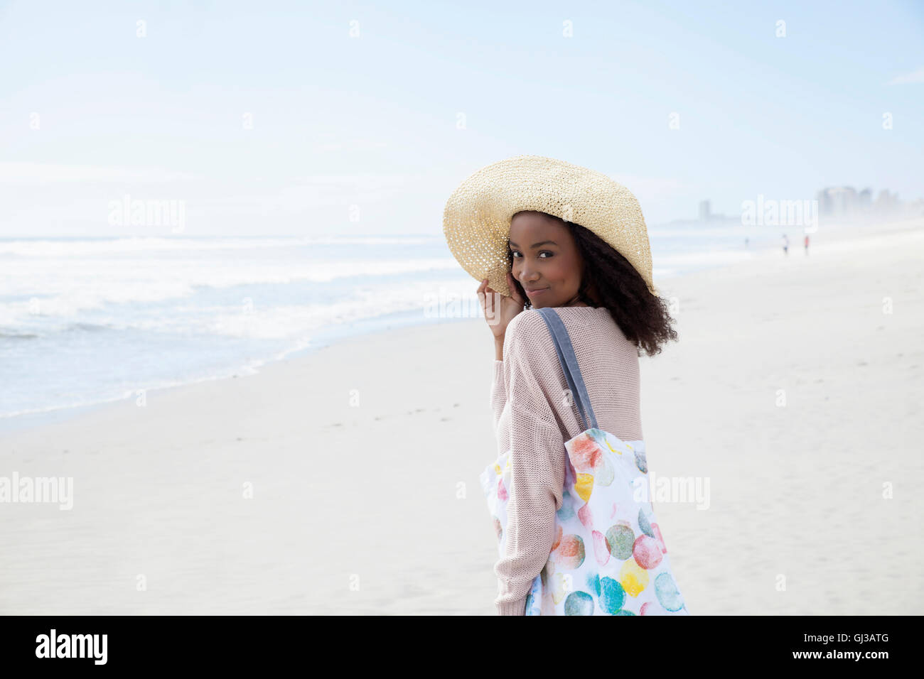 Young woman wearing hat on beach Stock Photo