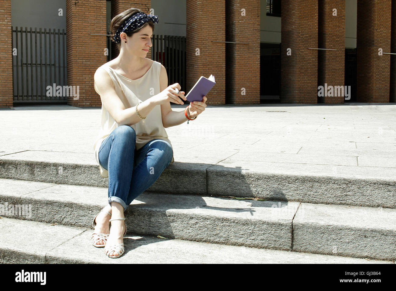 Woman sitting on steps hi-res stock photography and images - Alamy