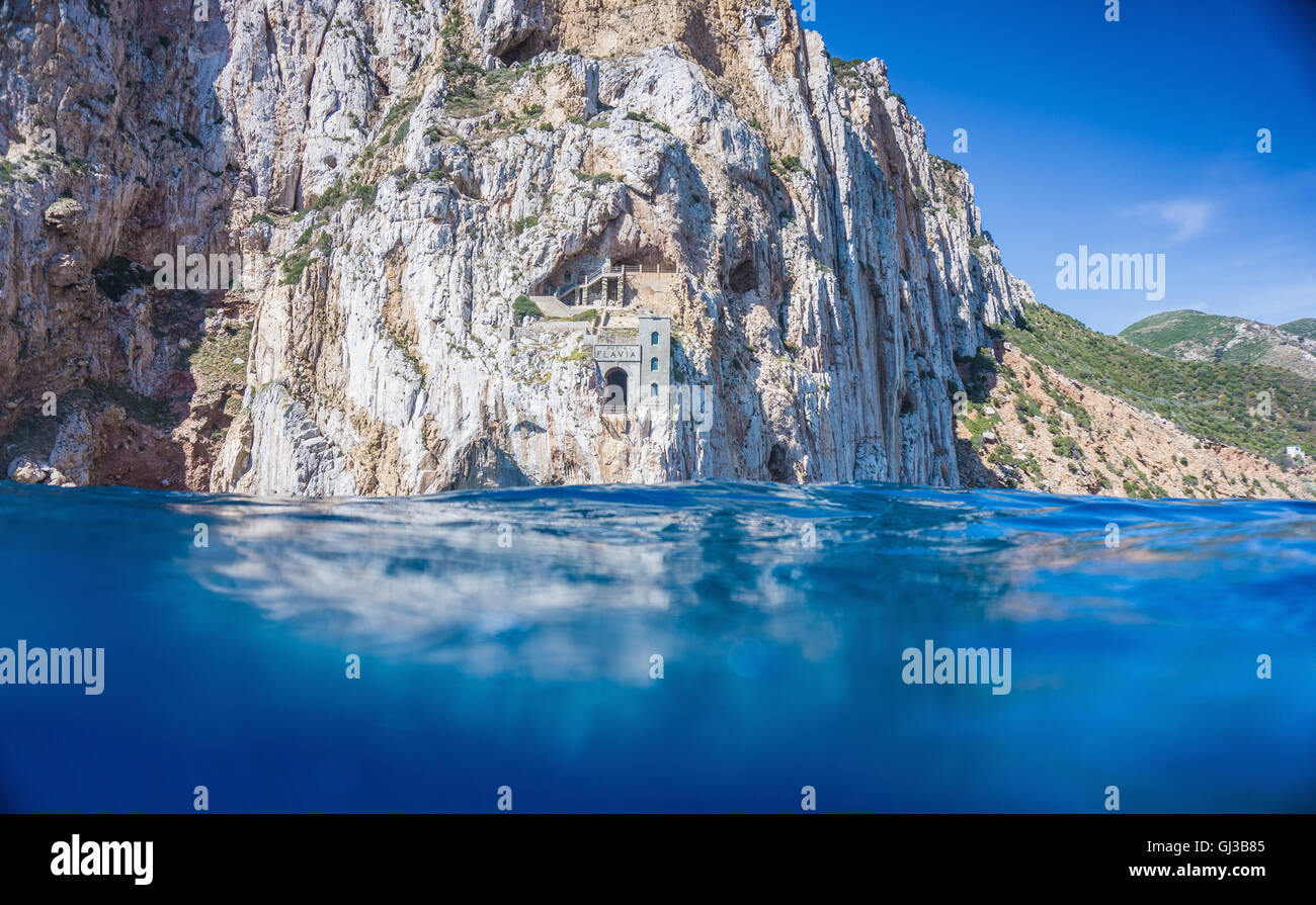 Above and below view of blue sea and cliffs, Masua, Italy Stock Photo