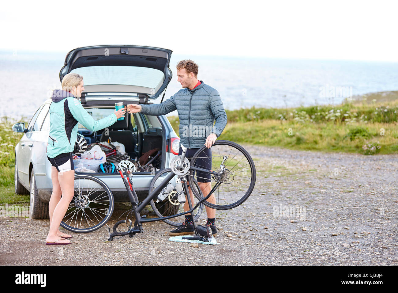 Cyclists preparing bicycle for ride Stock Photo