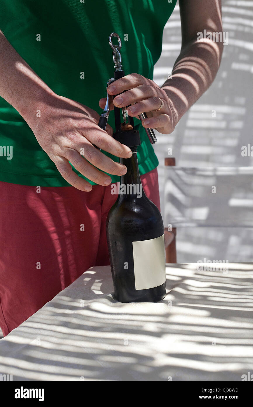 Man opening bottle of wine Stock Photo