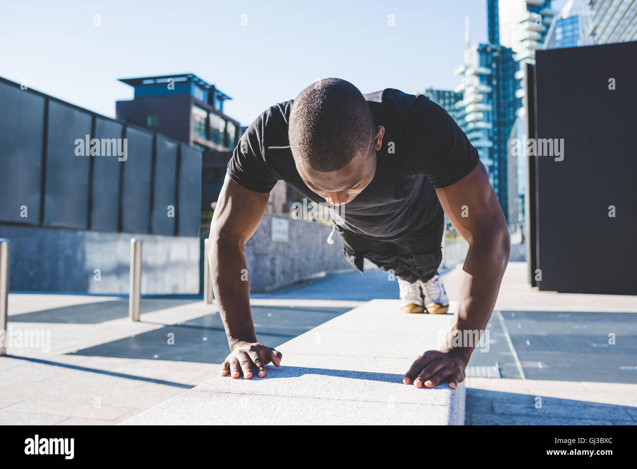 Young man exercising outdoors, doing push-ups Stock Photo - Alamy