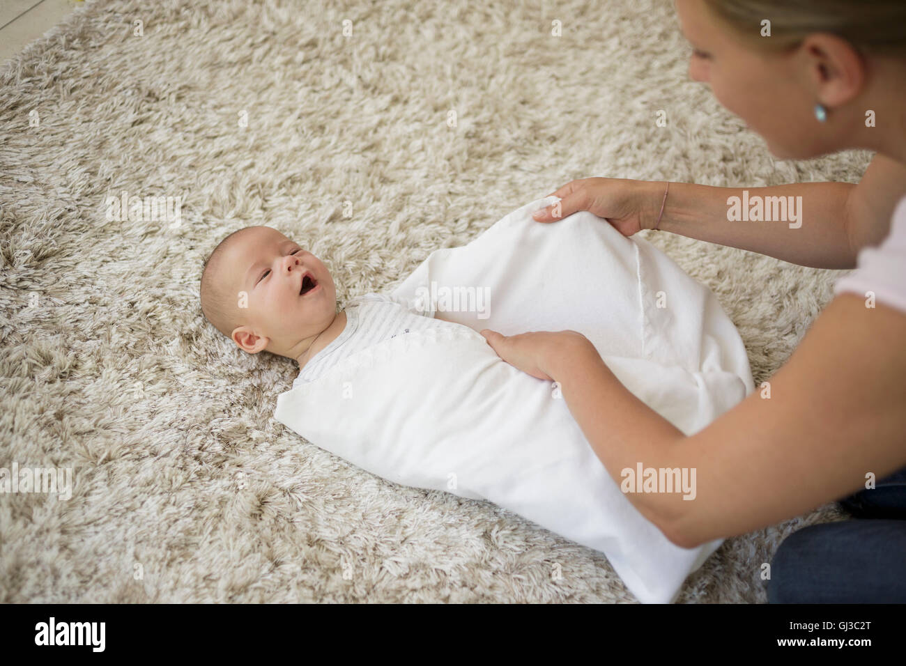 Mother and son wrapped in blanket hires stock photography and images