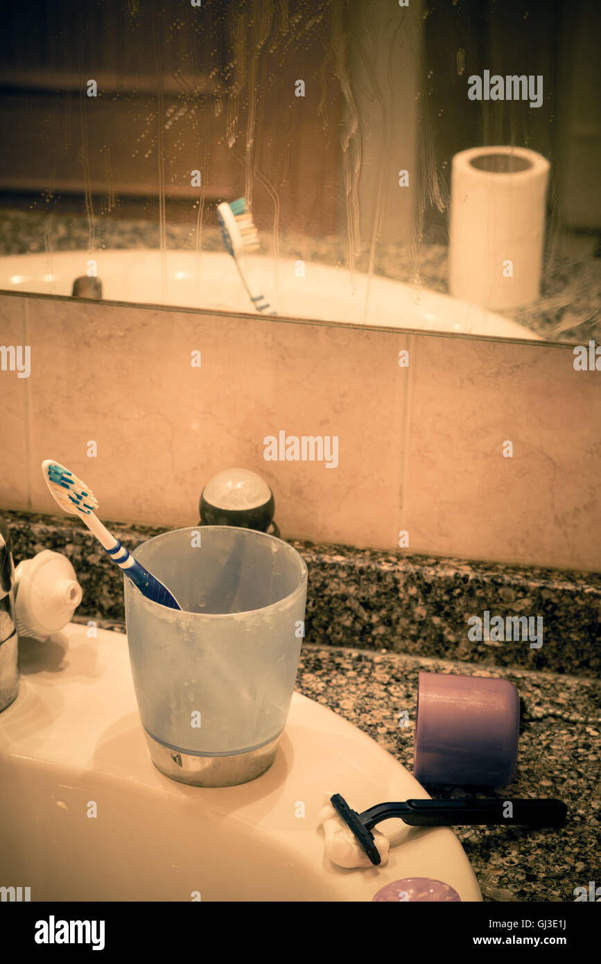 Bathroom sink in messy condition, a single male lifestyle concept Stock Photo