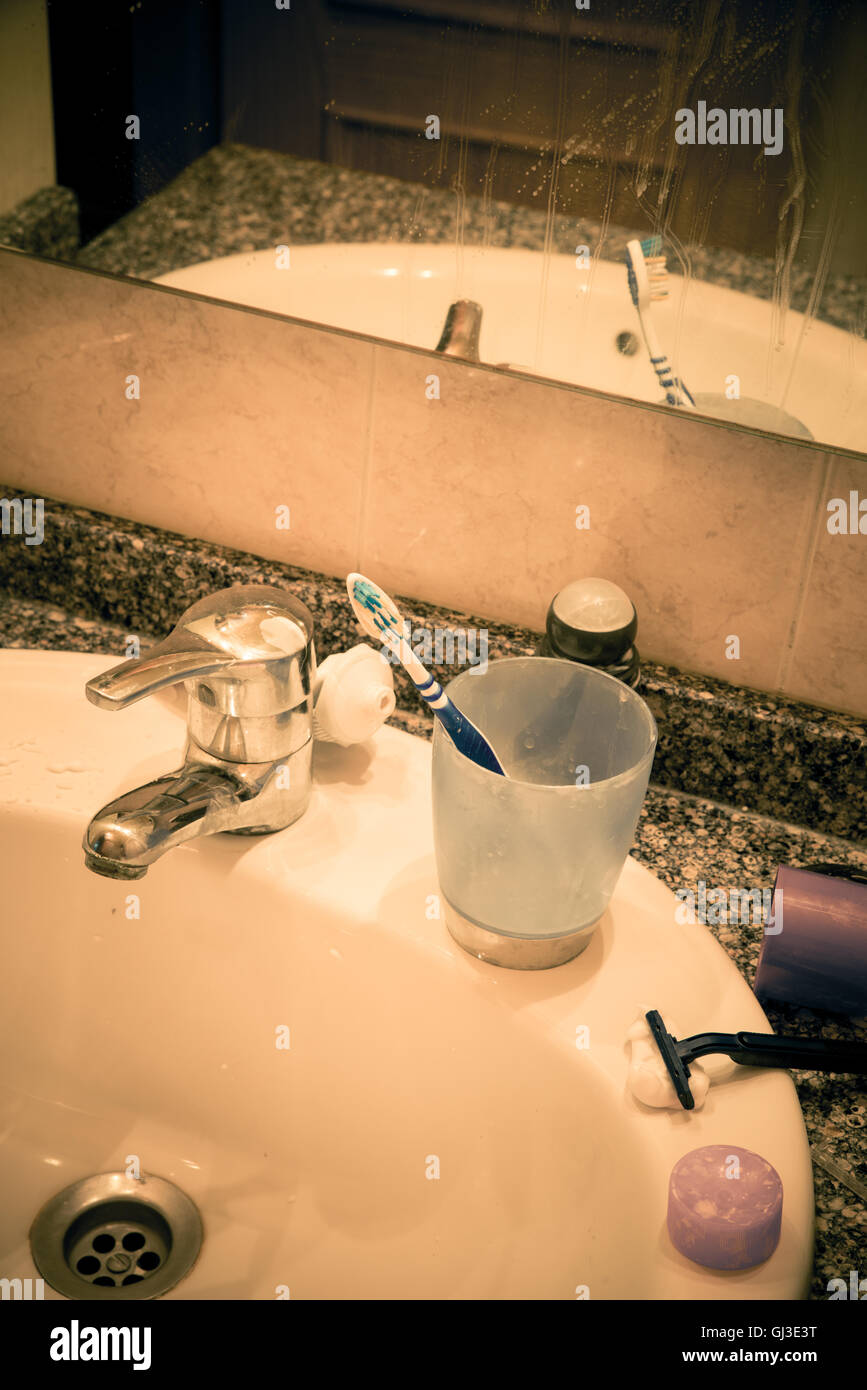Bathroom sink in messy condition, a single male lifestyle concept Stock Photo