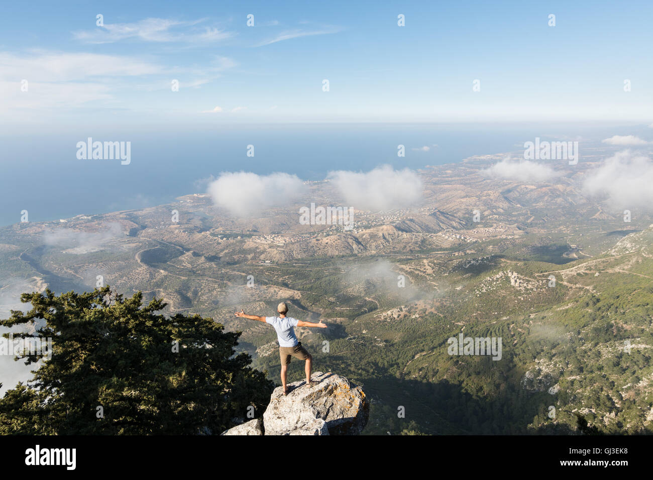 Man standing on the rock Stock Photo - Alamy