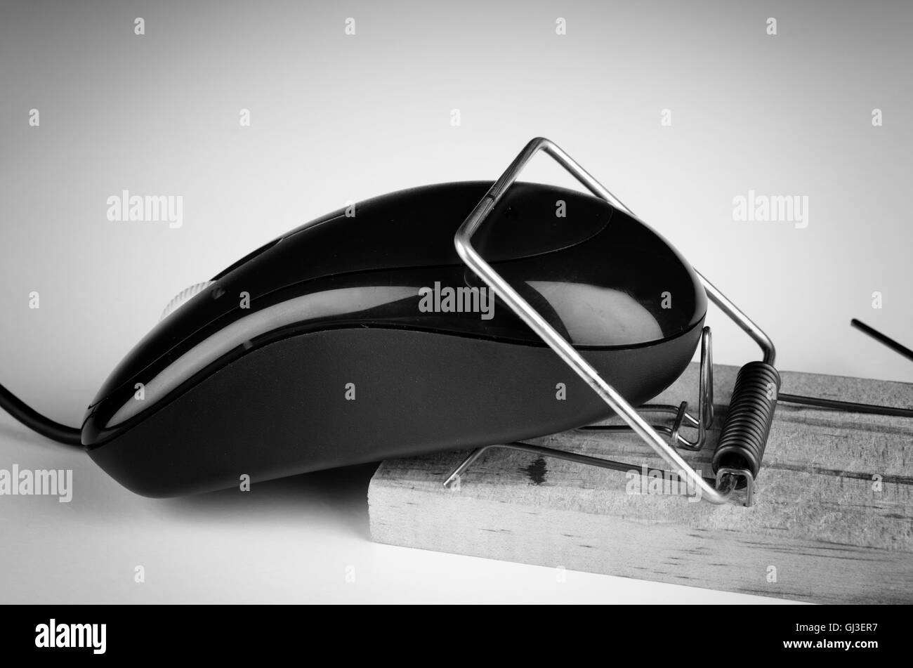 Computer mouse in a trap, a e commerce and computer addiction concept