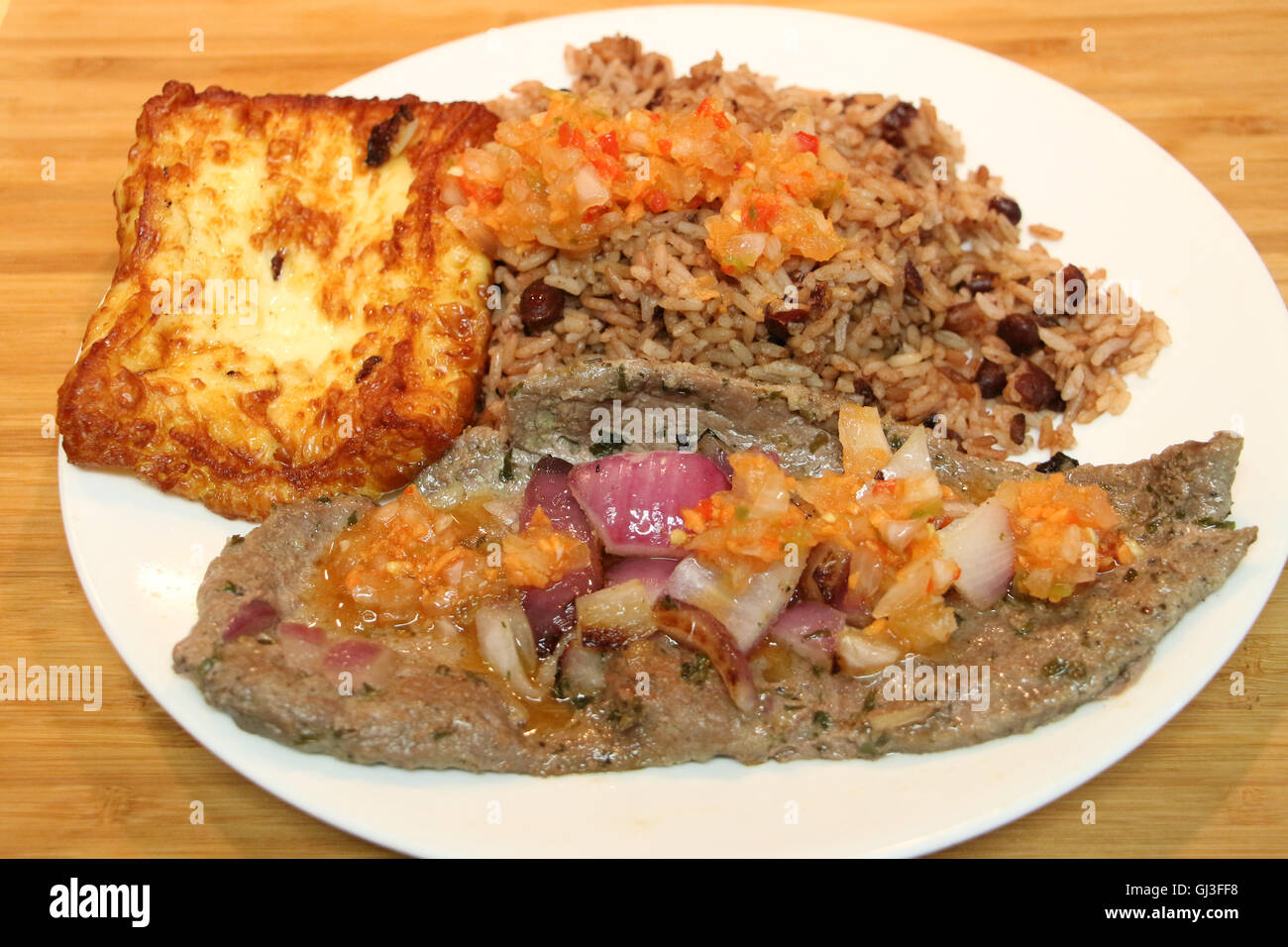 Flat iron Steak with Callo Pinto Rice and fried cheese a traditional dish of Costa Rica and Nicaragua Stock Photo