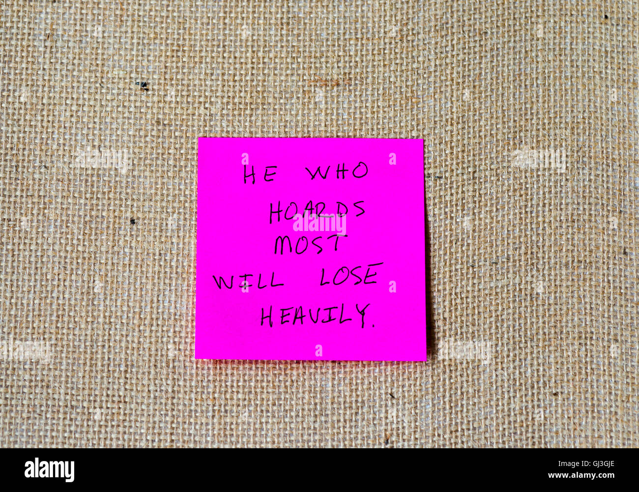 famous quote from the Tao Te Ching written on sticky notes, burlap background. Stock Photo