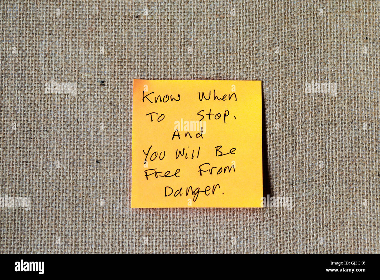 famous quote from the Tao Te Ching written on sticky notes, burlap background. Stock Photo