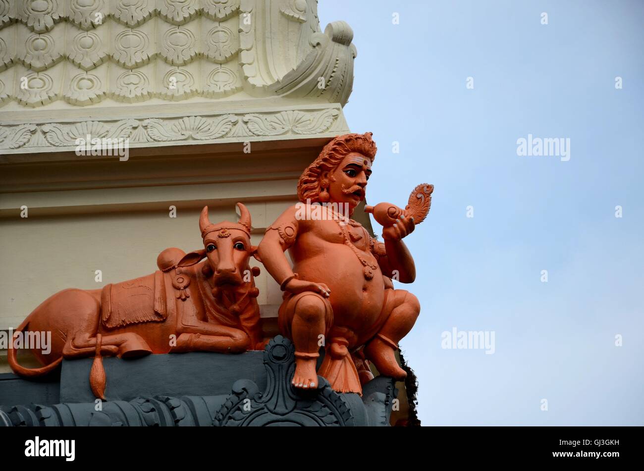 Statues of Nandi bull and one god holding conch at Sri Senpage Vinayagar Hindu temple Singapore Stock Photo