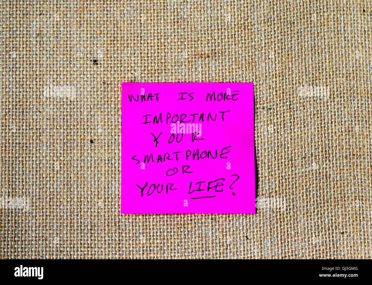 phrase 'what is more important, your smartphone or your life?' written on sticky notes Stock Photo