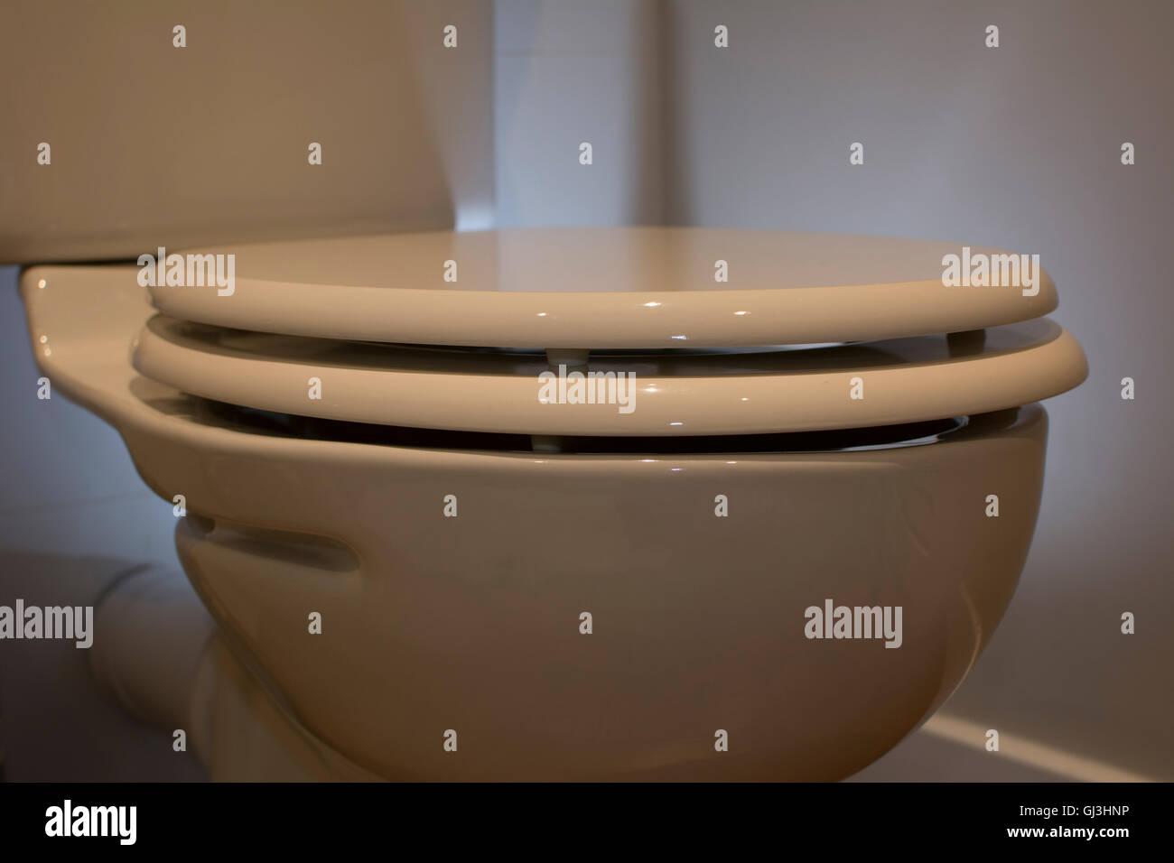 Clean looking back lit toilet bowl Stock Photo