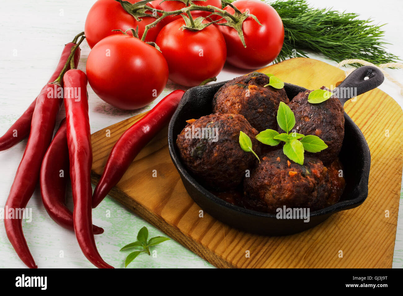 Grilled meatballs with chili pepper served in skillet. Grilled bbq