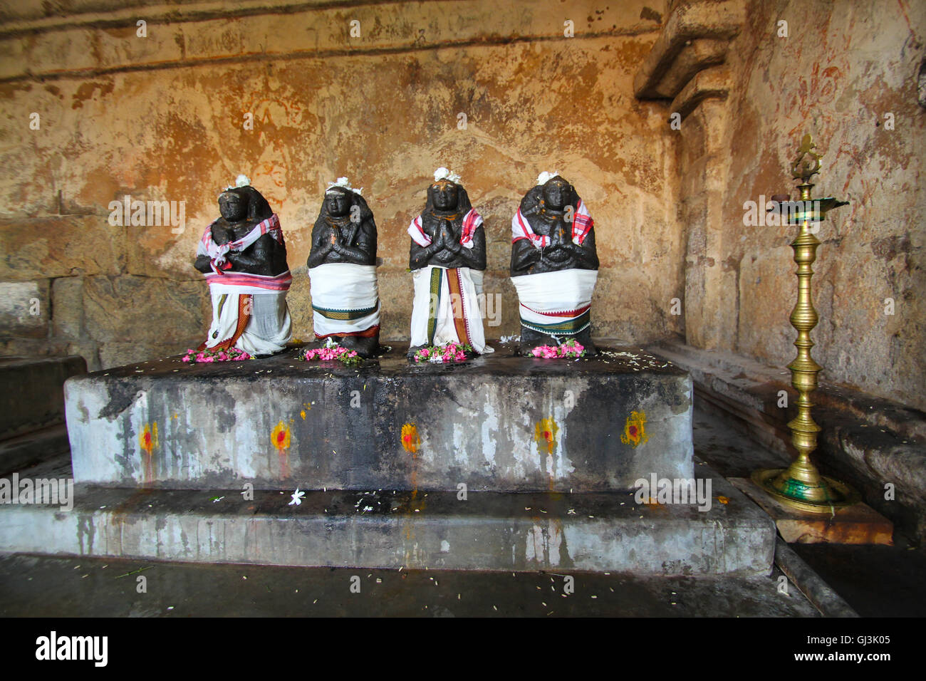 Blackened statue of idols, half covered with a white cloth seen at the Tanjavur Brihadeshwara Temple,TamilNadu. India Stock Photo