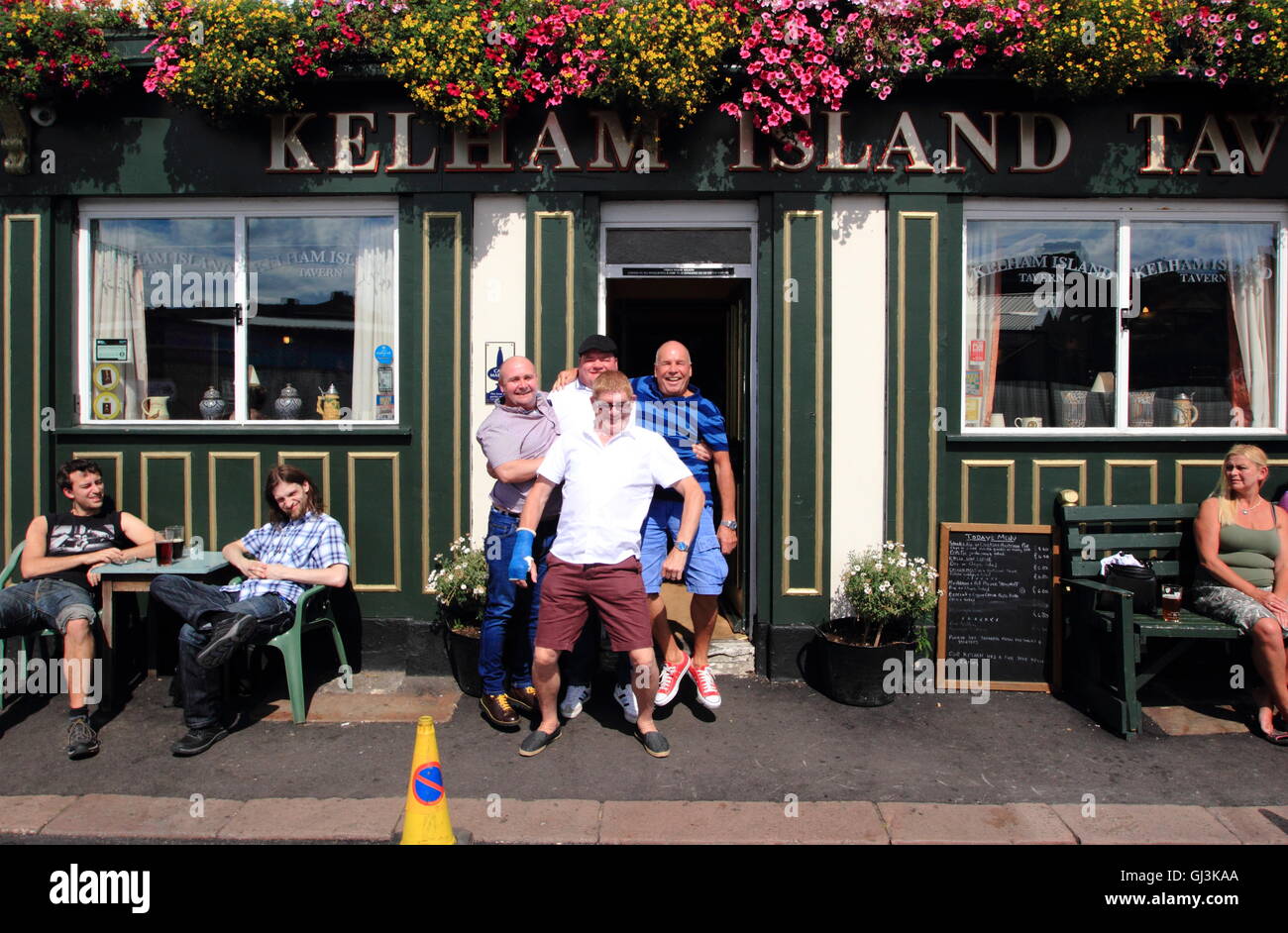 A group of men pose for a photo before entering Kelham Island Tavern, Kelham Island, Sheffield, South Yorkshire, England UK Stock Photo