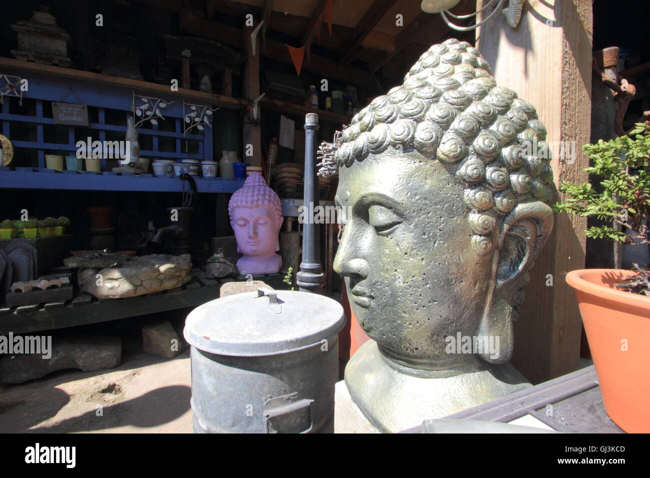 Buddha garden statuary for sale inside Swifties reclamation yard in the antiques quarter of the City of Sheffield, Yorkshire UK Stock Photo