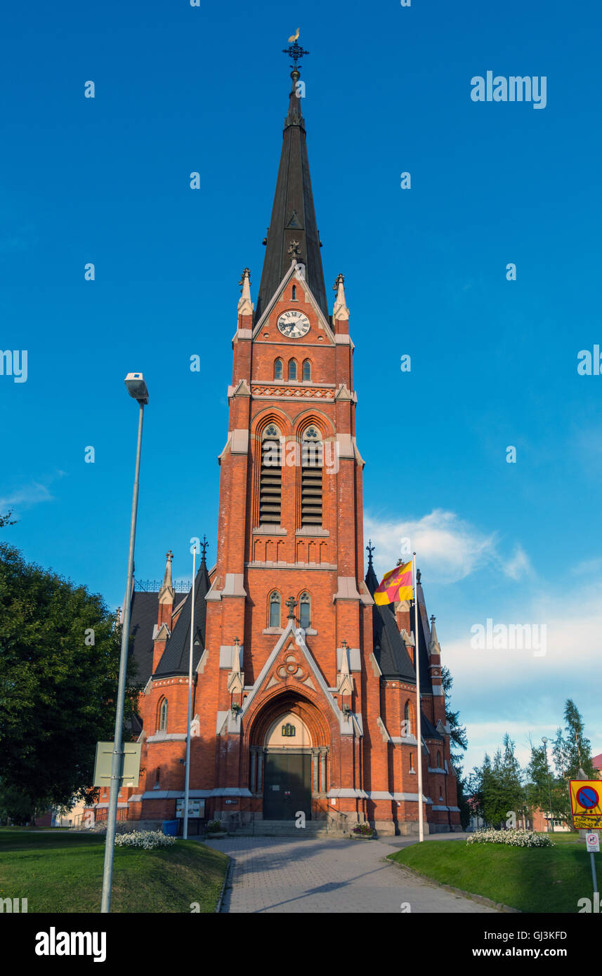 Red stone built church against blue sky, Lulea, Sweden Stock Photo