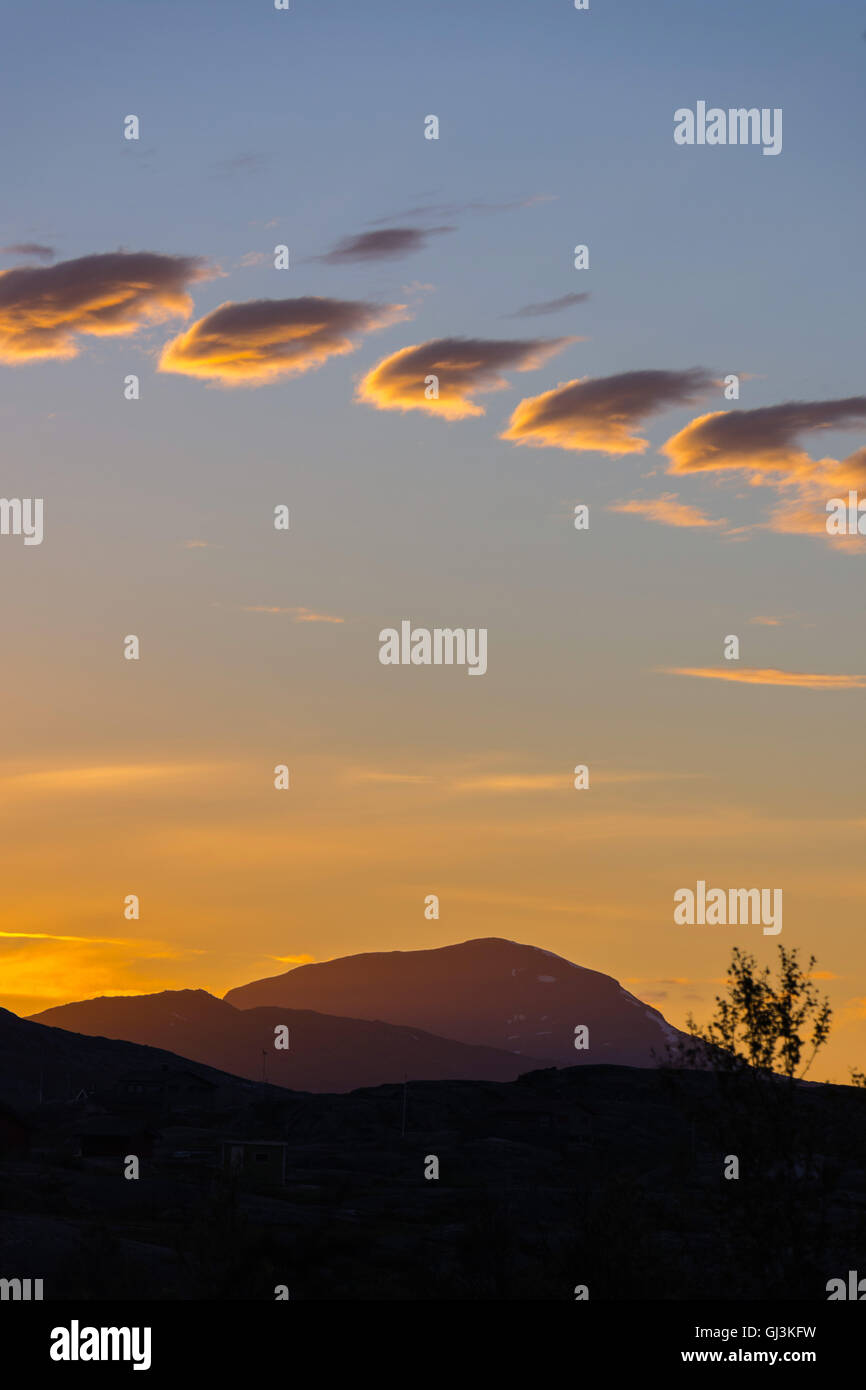 Line of small clouds at sunset, fair weather, Norway Stock Photo