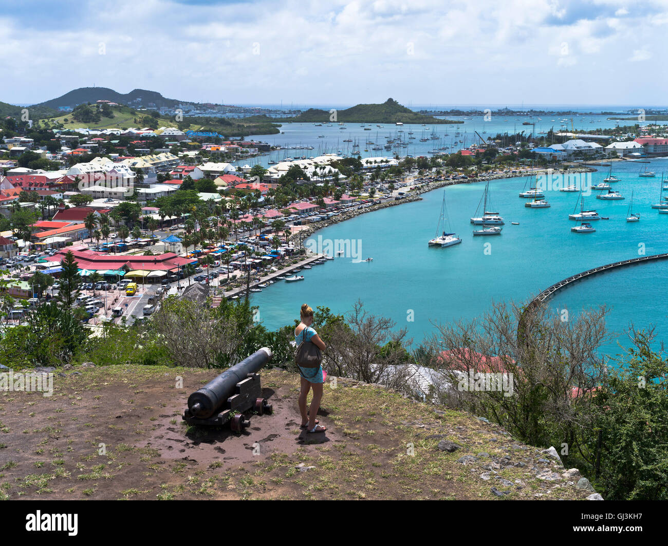 dh Marigot fort louis st martin SAINT MARTIN CARIBBEAN Tourist woman cannon port bay waterfront french town west indies Stock Photo