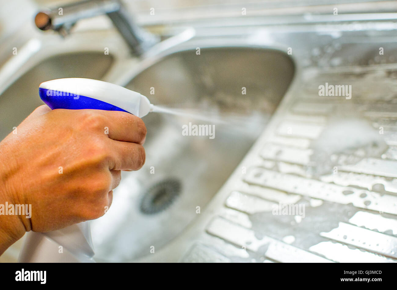 hand spray detergent on kitchen sink chores housekeeping Stock Photo
