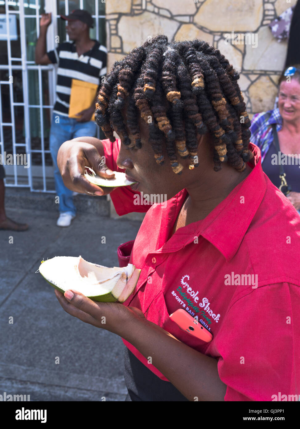 dh St GRENADA CARIBBEAN Woman scooping out inside flesh of