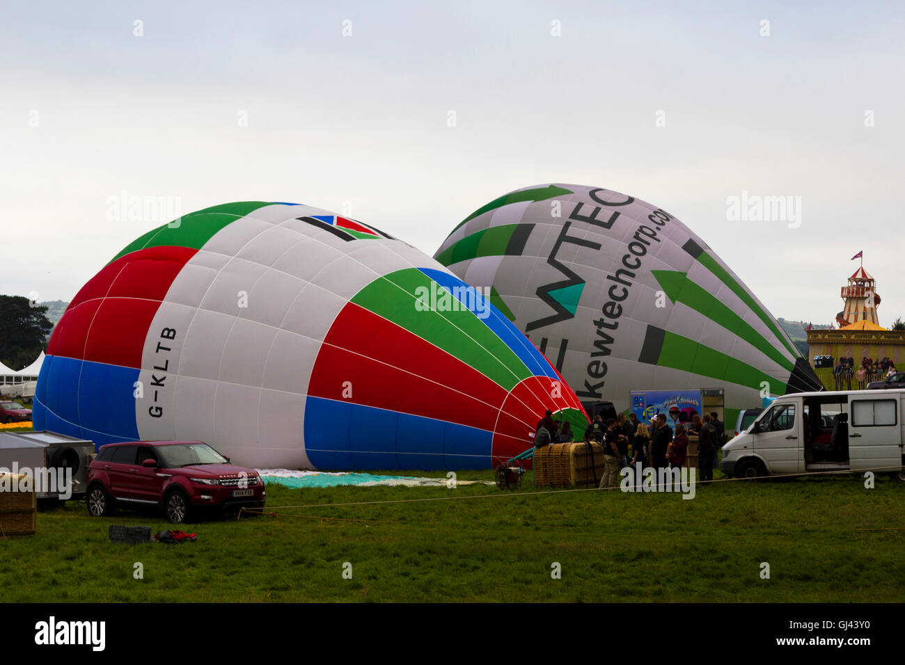 Bristol, UK. 12th Aug, 2016. The morning mass ascent is cancelled at the Bristol Balloon Fiesta due to gusts of wind, however several of the balloons remained for a tethered display. Credit:  Elizabeth Nunn/Alamy Live News Stock Photo