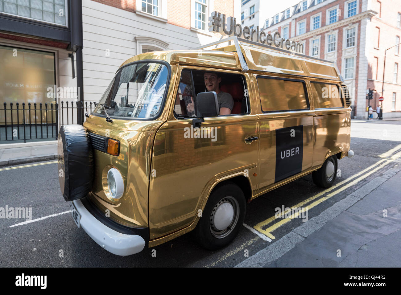 London, UK. 12 August 2016. A gold coloured VW camper van, marked as an UBER  ice cream van, is seen in Mayfair. Users of UBER's new food ordering app,  UBER Eats, can
