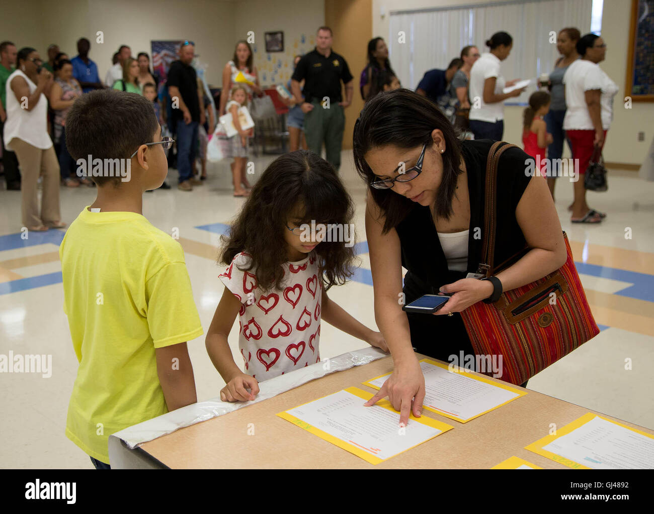 West Palm Beach, Florida, USA. 12th Aug, 2016. Sandra Victoria, (right) checks the bus routes