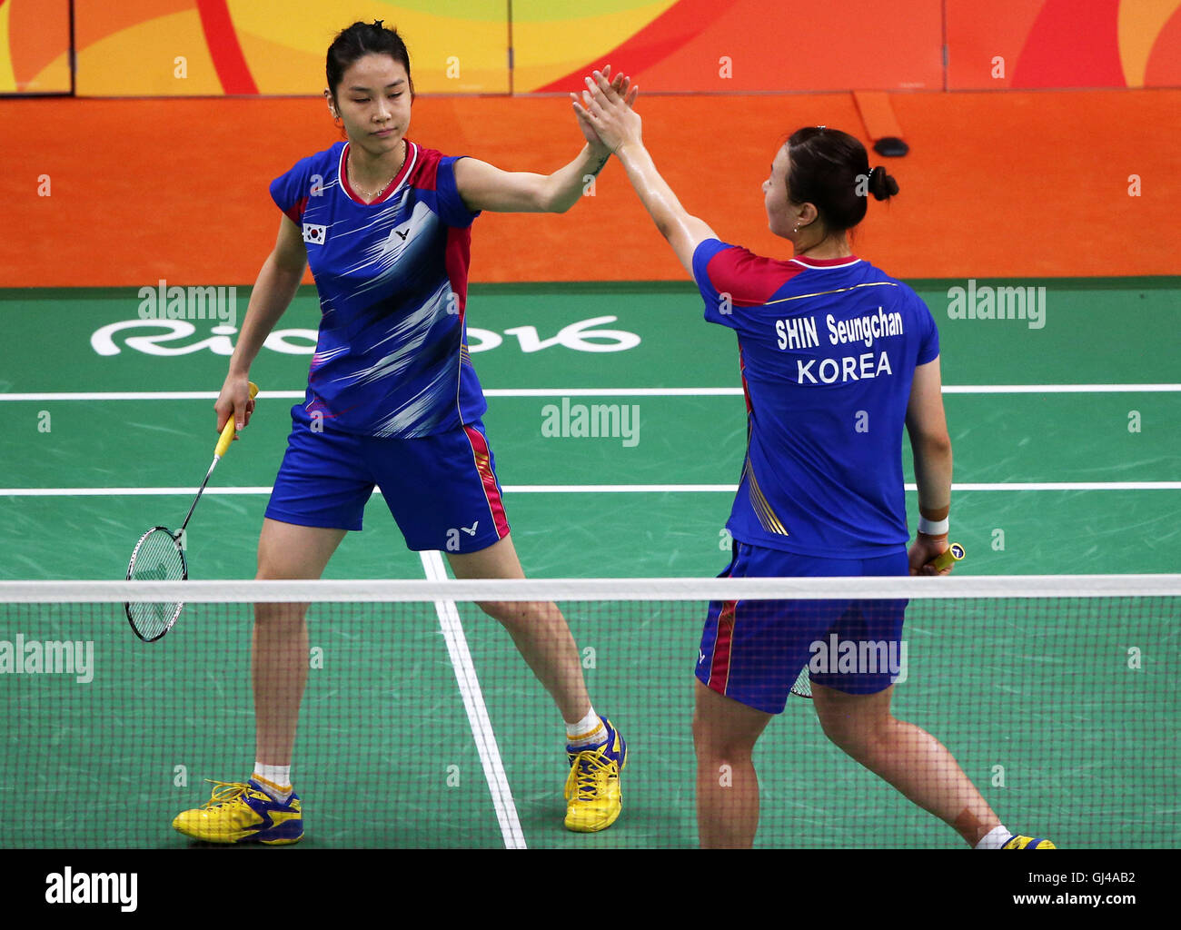 Rio De Janeiro, Brazil. 12th Aug, 2016. South Korea's Jung Kyung Eun (L) and Shin Seung Chan react during women's doubles group play stage match of Badminton against China's Luo Ying and Luo Yu at the 2016 Rio Olympic Games in Rio de Janeiro, Brazil, on Aug. 12, 2016. Jung Kyung Eun and Shin Seung Chang won the match 2-0. Credit:  Qin Lang/Xinhua/Alamy Live News Stock Photo