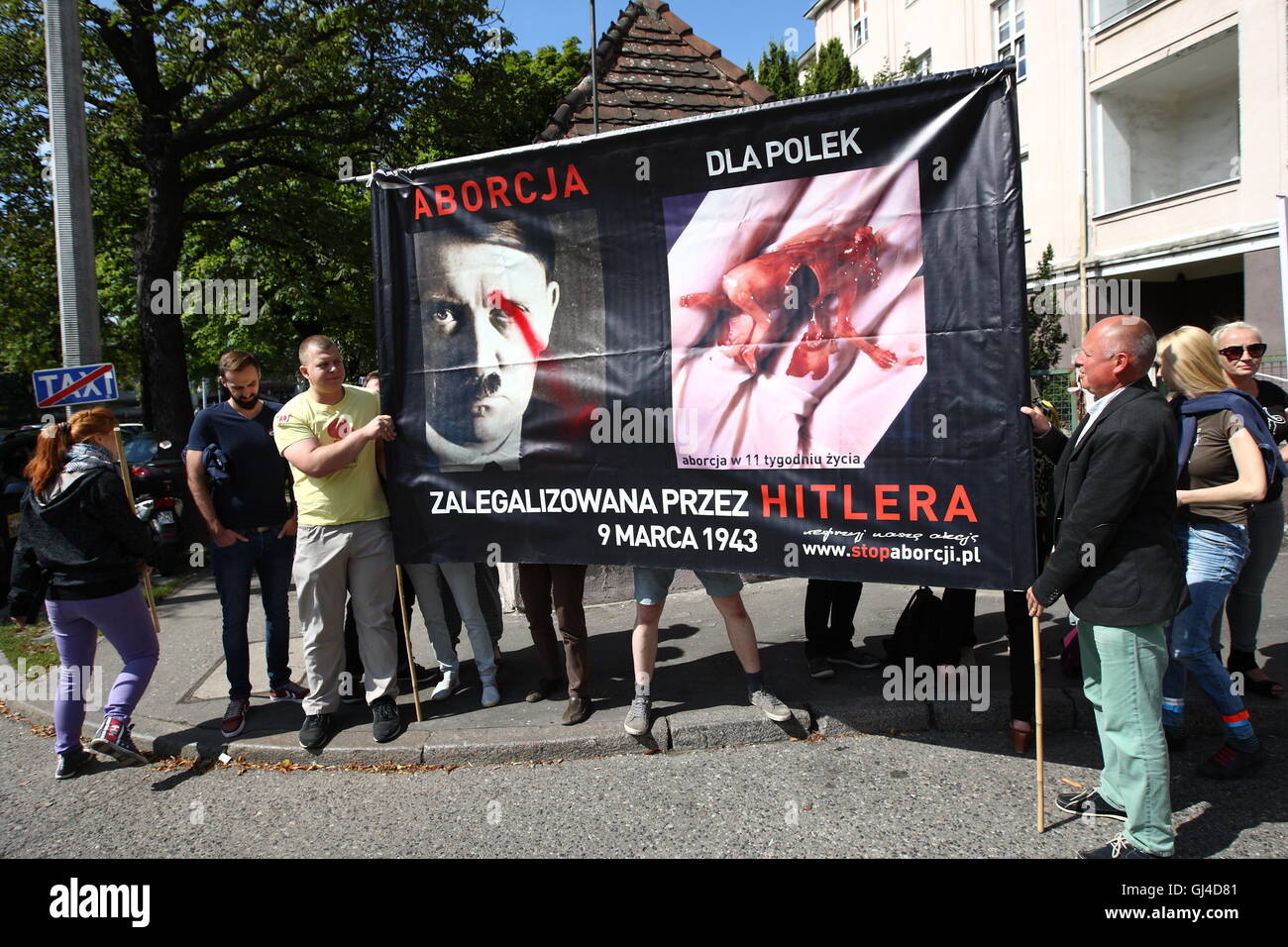 Gdansk, Poland. 13th Aug, 2016. Two demonstrations - one opponents toughen abortion laws in Poland, the other - followers of a total ban on abortion from far right, and catholic church organizations met in front of the Clinical Hospital in Gdansk, where are carried out legal abortions. The far right has brought together banners with pictures of dead fetuses. Their opponents demanded freedom of choice for women who want to make a legal abortion. Credit:  Michal Fludra/Alamy Live News Stock Photo