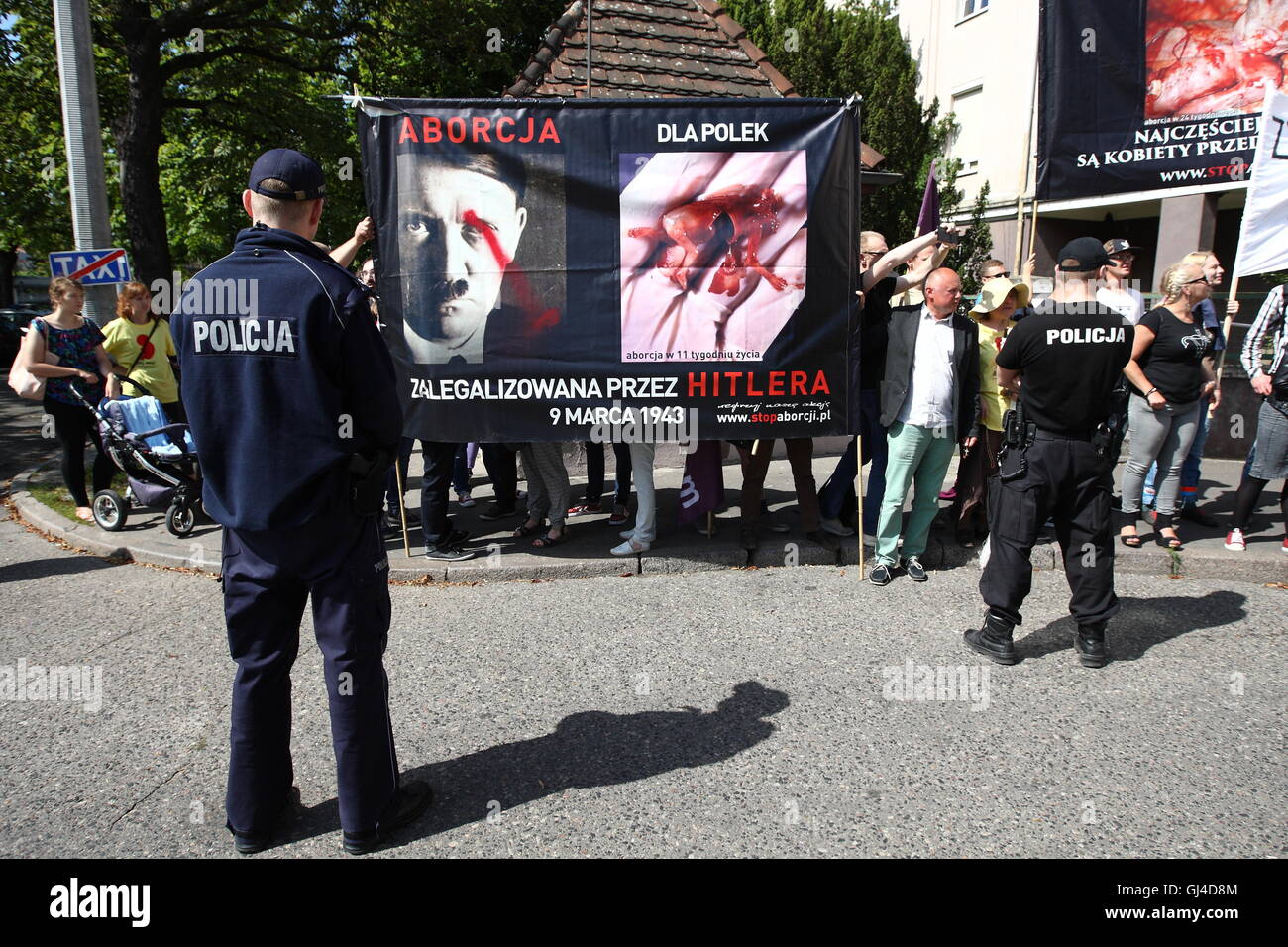 Gdansk, Poland. 13th Aug, 2016. Two demonstrations - one opponents toughen abortion laws in Poland, the other - followers of a total ban on abortion from far right, and catholic church organizations met in front of the Clinical Hospital in Gdansk, where are carried out legal abortions. The far right has brought together banners with pictures of dead fetuses. Their opponents demanded freedom of choice for women who want to make a legal abortion. Credit:  Michal Fludra/Alamy Live News Stock Photo