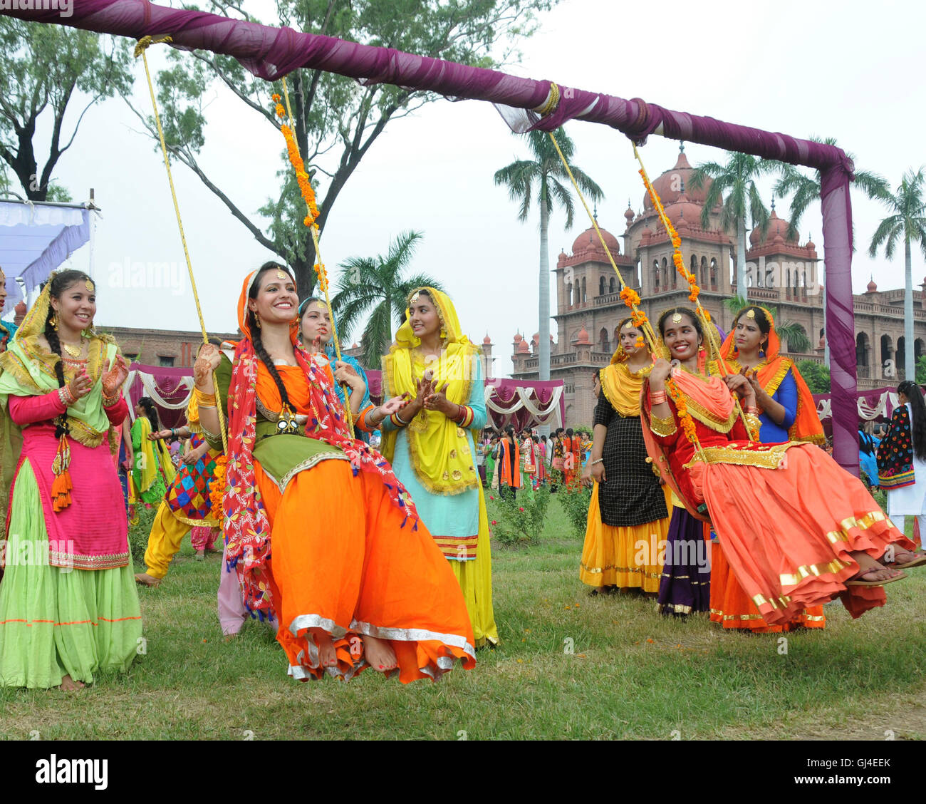 (160813) -- AMRITSAR (INDIA), Aug. 13, 2016 (Xinhua) -- College girls wearing traditional Punjabi dresses swing during the celebration of Teej Festival in Amritsar, India, Aug. 13, 2016. Teej is a generic name for a number of festivals celebrated among females to welcome monsoon season in northern and western India and Nepal. (xinhua/stringer) (wtc) Stock Photo