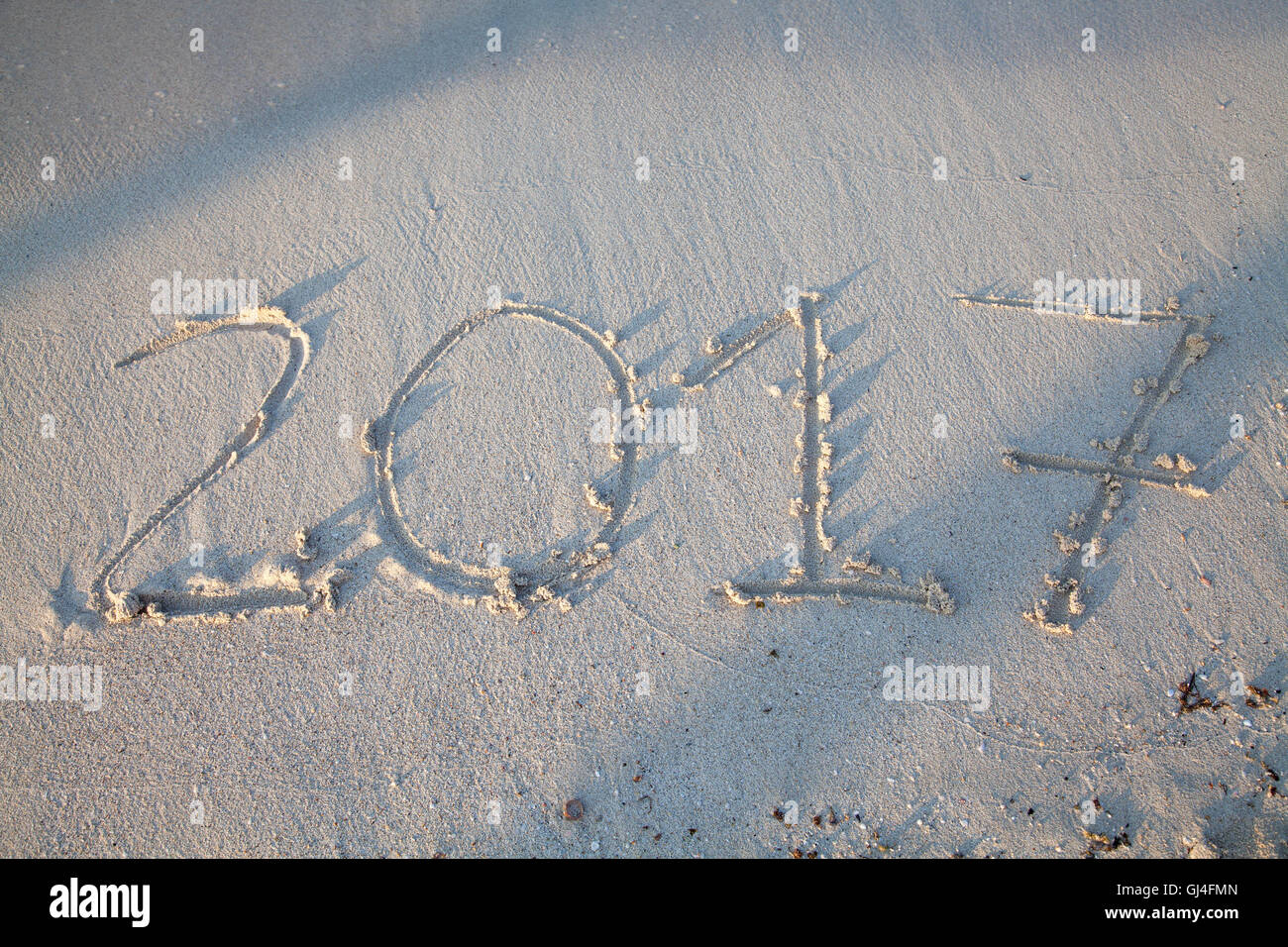 Year and number 2017 written on the sand on a beach Stock Photo